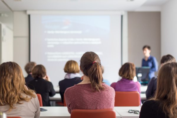 Female,Speaker,Giving,Presentation,In,Lecture,Hall,At,University,Workshop. Female,Speaker,Giving,Presentation,In,Lecture,Hall,At,University,Workshop.