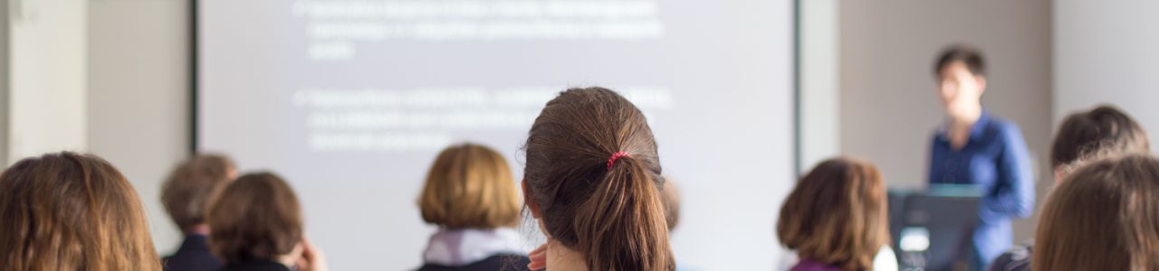 Female,Speaker,Giving,Presentation,In,Lecture,Hall,At,University,Workshop. Female,Speaker,Giving,Presentation,In,Lecture,Hall,At,University,Workshop.